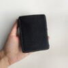 The back of the black velour leather playing cards case, held in hand.