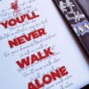 Zoom in on the “You’ll Never Walk Alone” print, with lyrics.