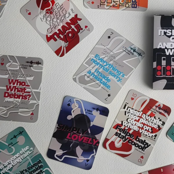 F1 Radio Messages Playing Cards deck spread on a table, showing illustrated iconic F1 quotes, standard poker size 63.5 x 88.8mm. "Simply Lovely" Verstappen quote card.